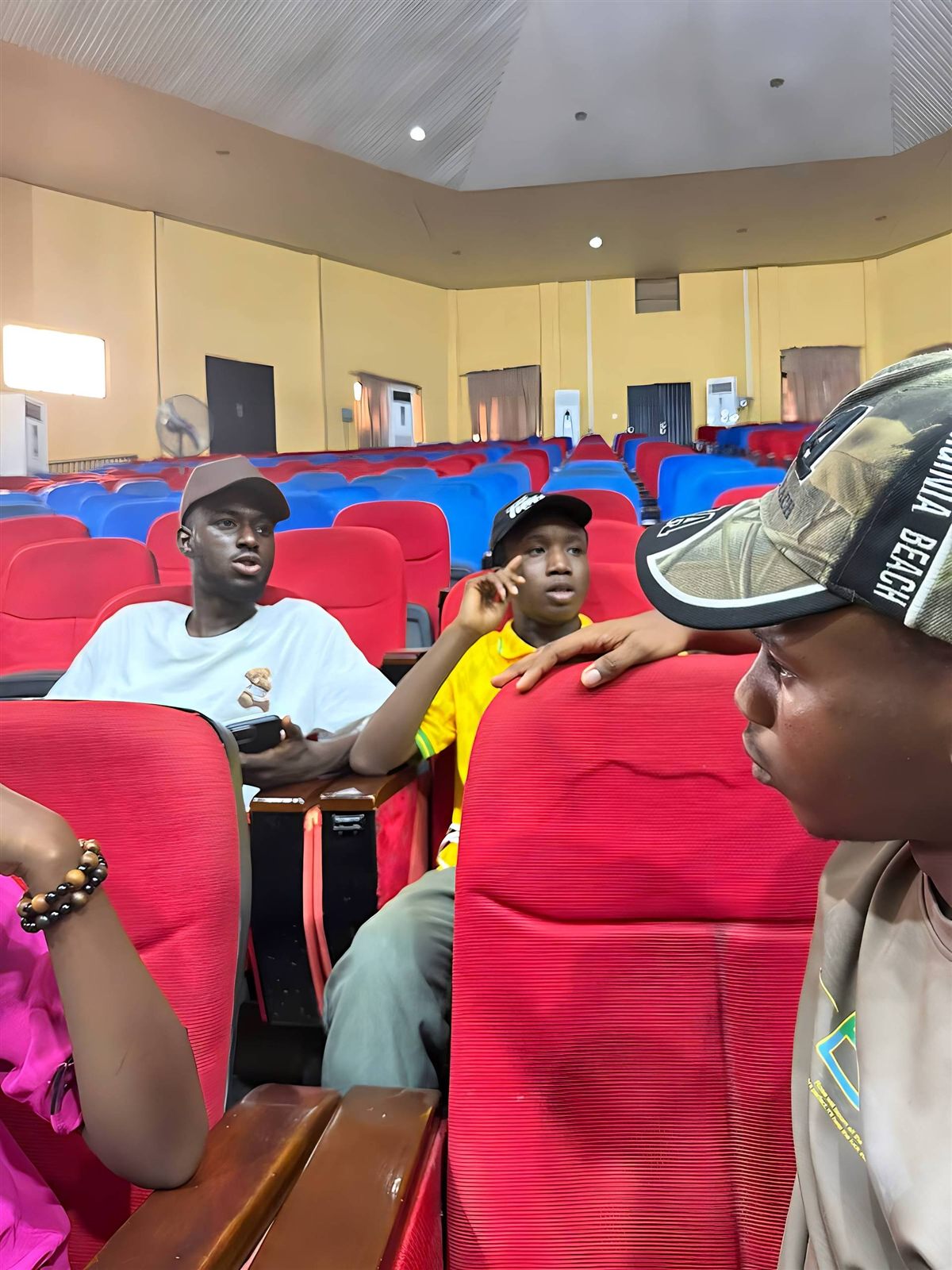 Members of the NACSS executive team talking in the red auditorium seats